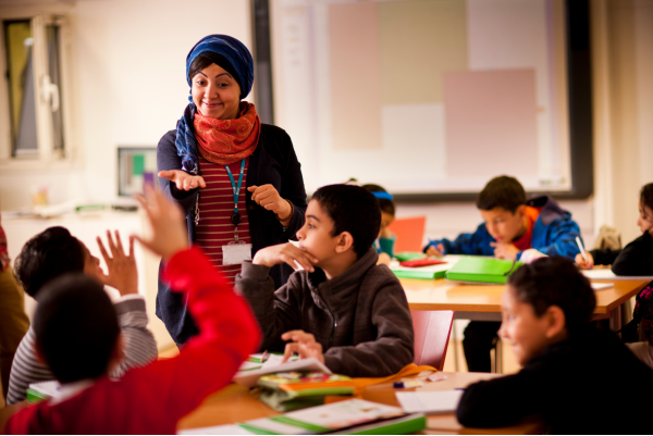 Teacher with a group of young students in a classroom