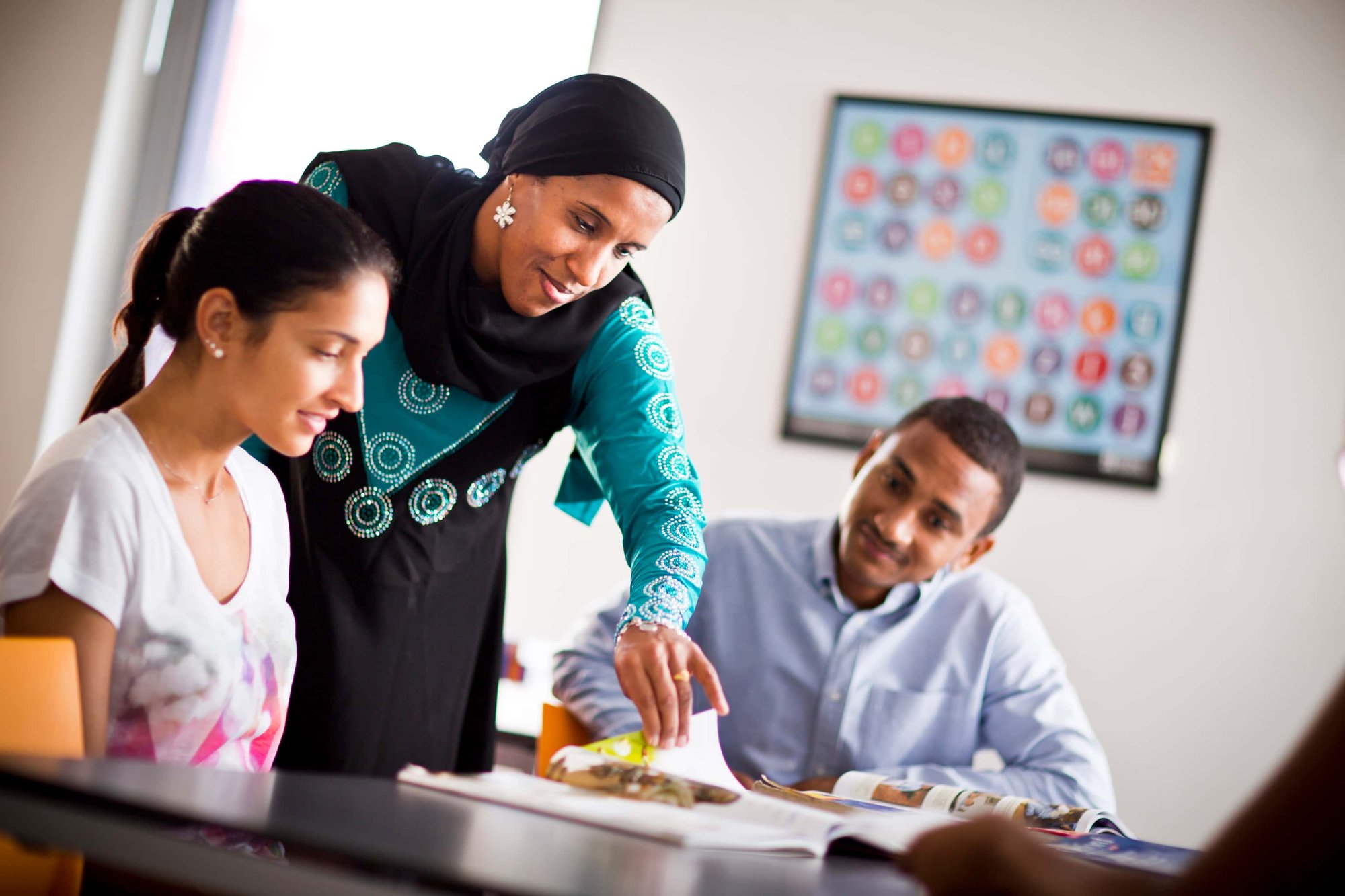 Teacher showing how to change an international exam