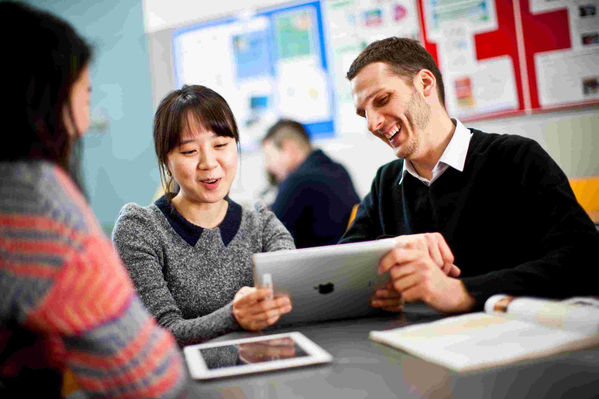 Students checking international schools exams FAQs on a tablet